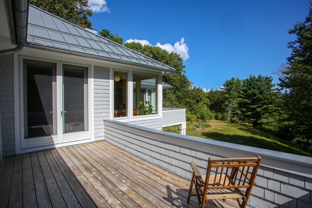 240 Beldingville Road Ashfield, MA 01330 - Photo 25 of 40 a view of a chair and tables in the balcony