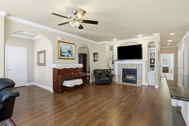 a living room with furniture a fireplace and a flat screen tv