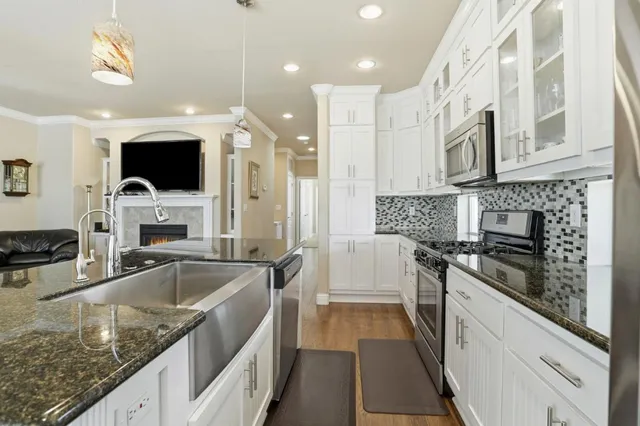 a large kitchen with a stove and a sink