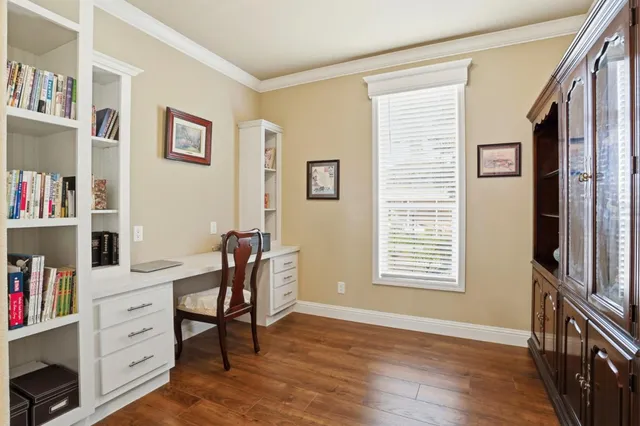 a view of a workspace with furniture and a window