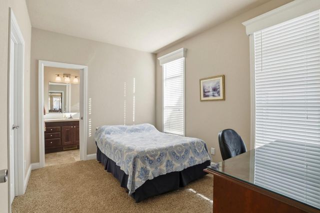 a bedroom with a bed and a desk