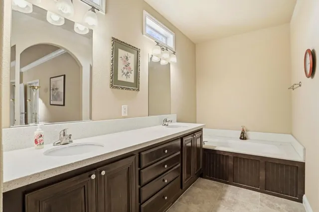 a bathroom with a double vanity sink and a mirror
