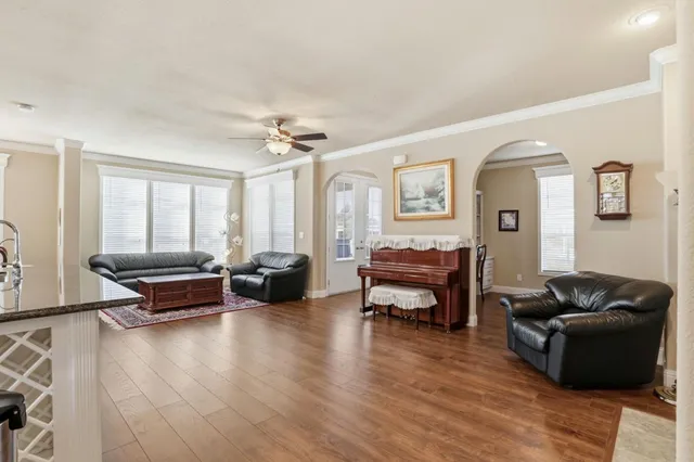 a living room with furniture and wooden floor