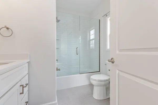 a bathroom with a toilet a sink and shower