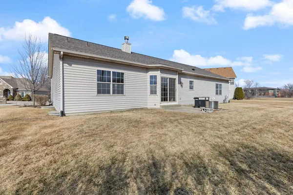 a view of a house with a backyard