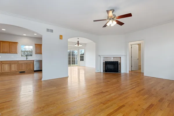a view of a room with wooden floor and a fireplace