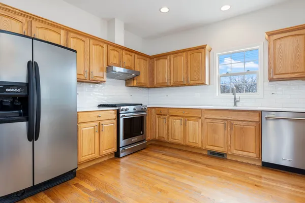 a kitchen with stainless steel appliances white cabinets and a sink