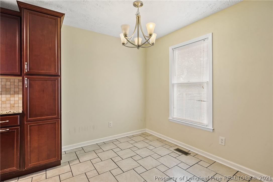 6568 Applewhite Road Fayetteville, NC 28304 - Photo 12 of 46 an empty room with windows