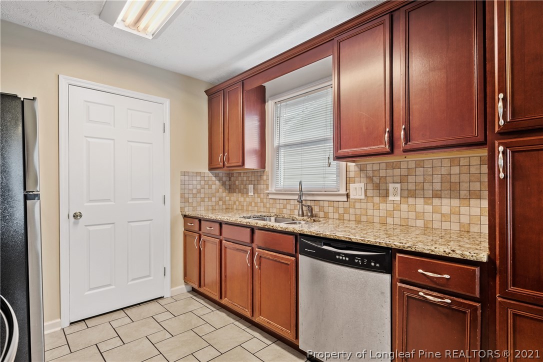 6568 Applewhite Road Fayetteville, NC 28304 - Photo 19 of 46 a kitchen with stainless steel appliances granite countertop a sink and a cabinets