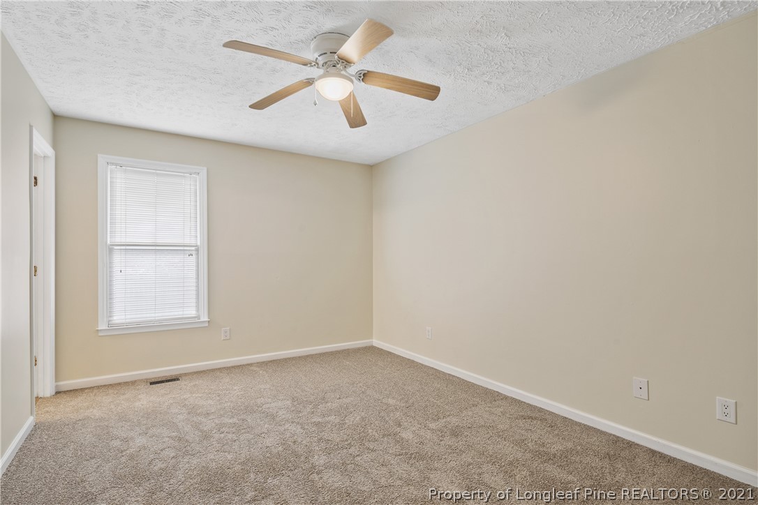6568 Applewhite Road Fayetteville, NC 28304 - Photo 24 of 46 an empty room with windows and fan