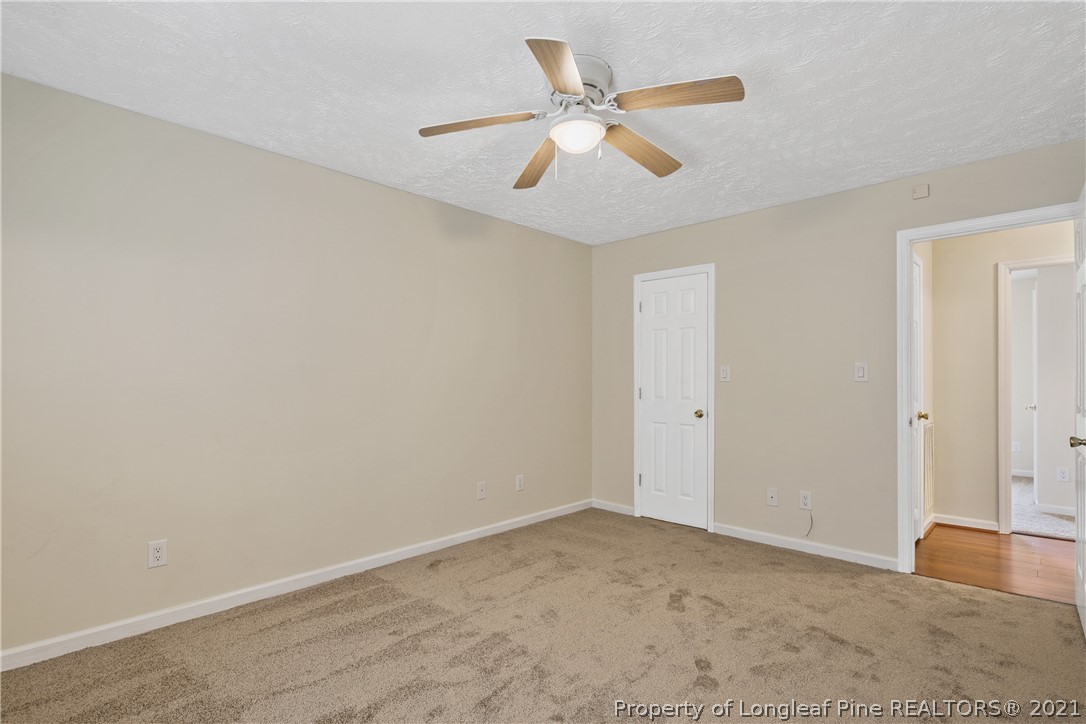 6568 Applewhite Road Fayetteville, NC 28304 - Photo 25 of 46 an empty room with closet and fan
