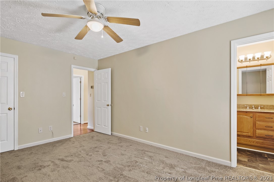 6568 Applewhite Road Fayetteville, NC 28304 - Photo 26 of 46 an empty room with closet and windows