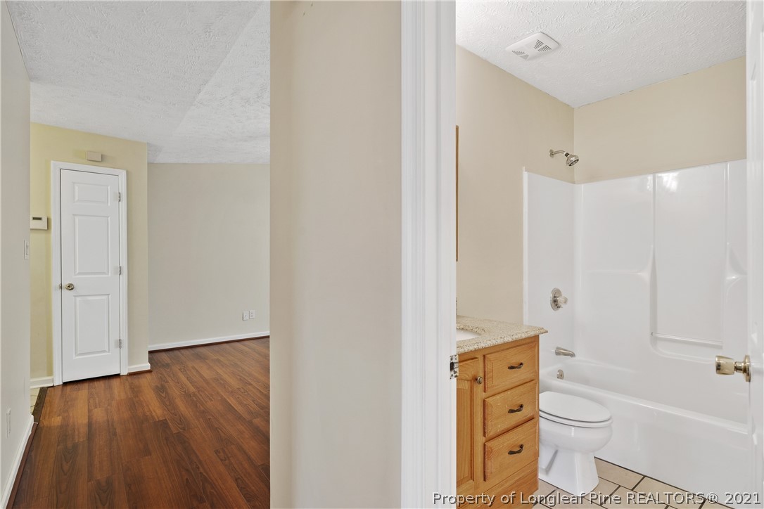 6568 Applewhite Road Fayetteville, NC 28304 - Photo 36 of 46 a bathroom with a toilet a sink and bathtub