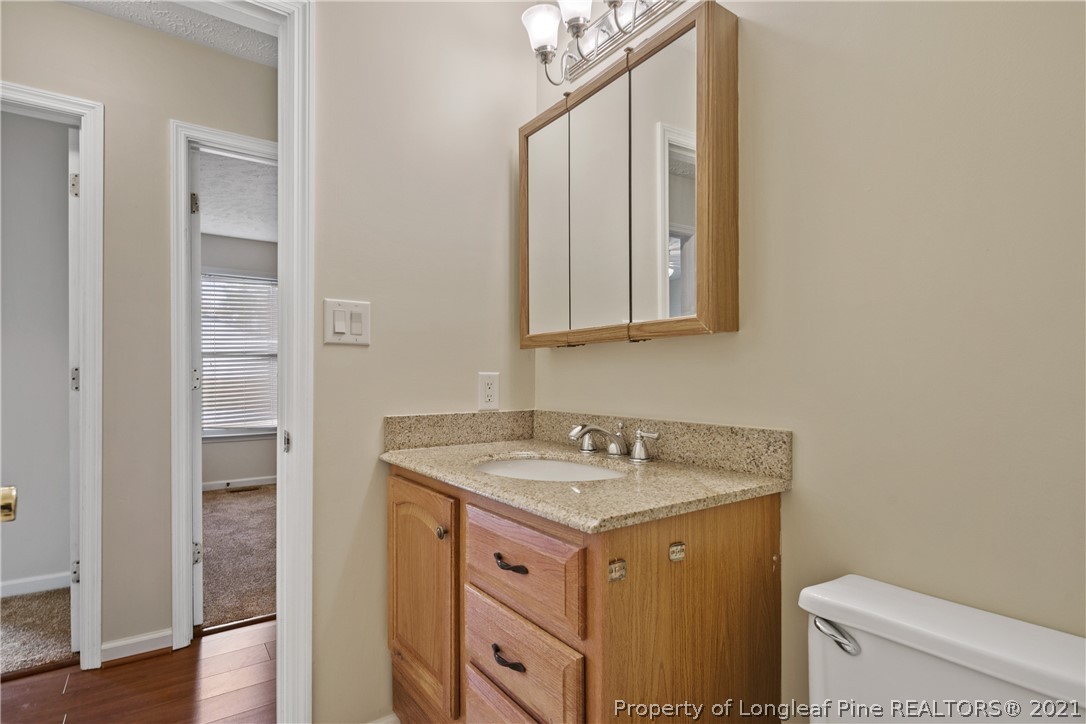 6568 Applewhite Road Fayetteville, NC 28304 - Photo 38 of 46 a bathroom with a sink a toilet and a mirror