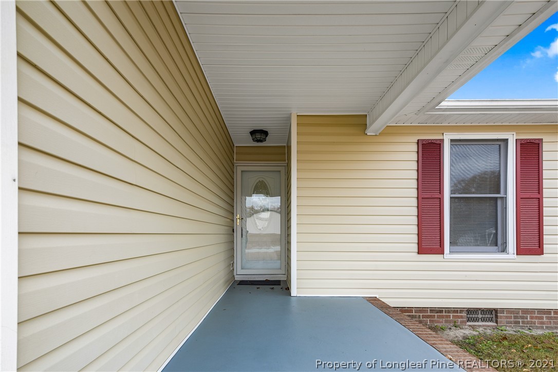 6568 Applewhite Road Fayetteville, NC 28304 - Photo 4 of 46 a view of a house with a door and wooden walls