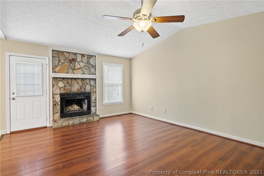 6568 Applewhite Road Fayetteville, NC 28304 - Photo 8 of 46 wooden floor fireplace and windows in an empty room