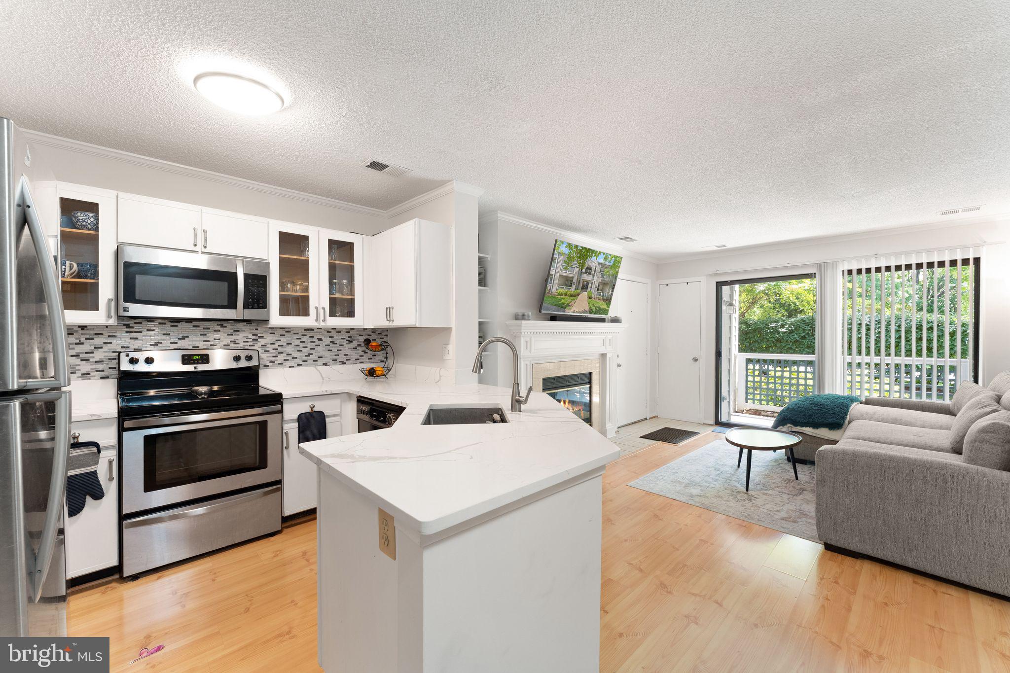 11741 Summerchase Circle, Unit A Reston, VA 20194 - Photo 18 of 32 a view of living room kitchen with stainless steel appliances stove microwave and refrigerator