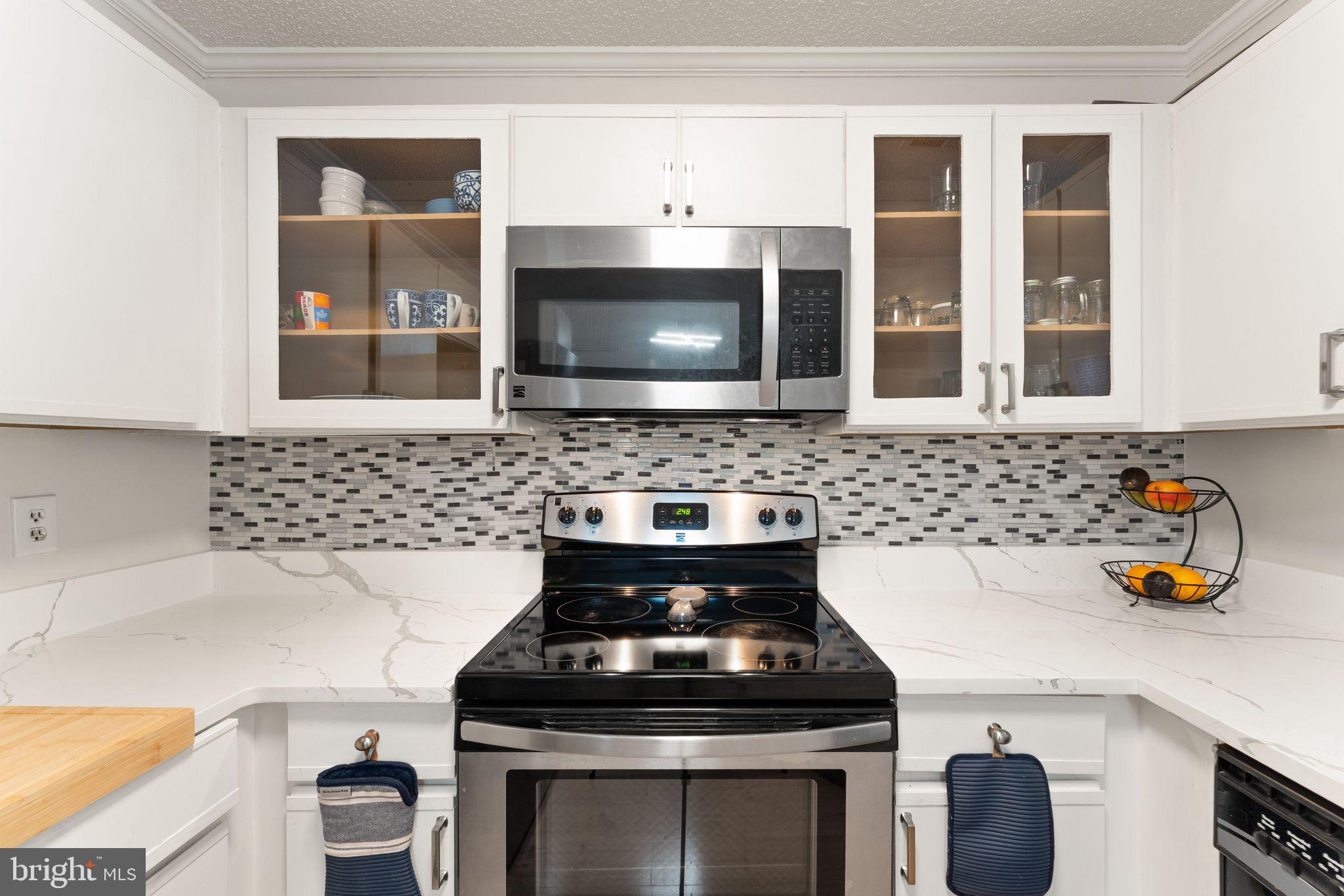 11741 Summerchase Circle, Unit A Reston, VA 20194 - Photo 19 of 32 a kitchen with a stove and a microwave