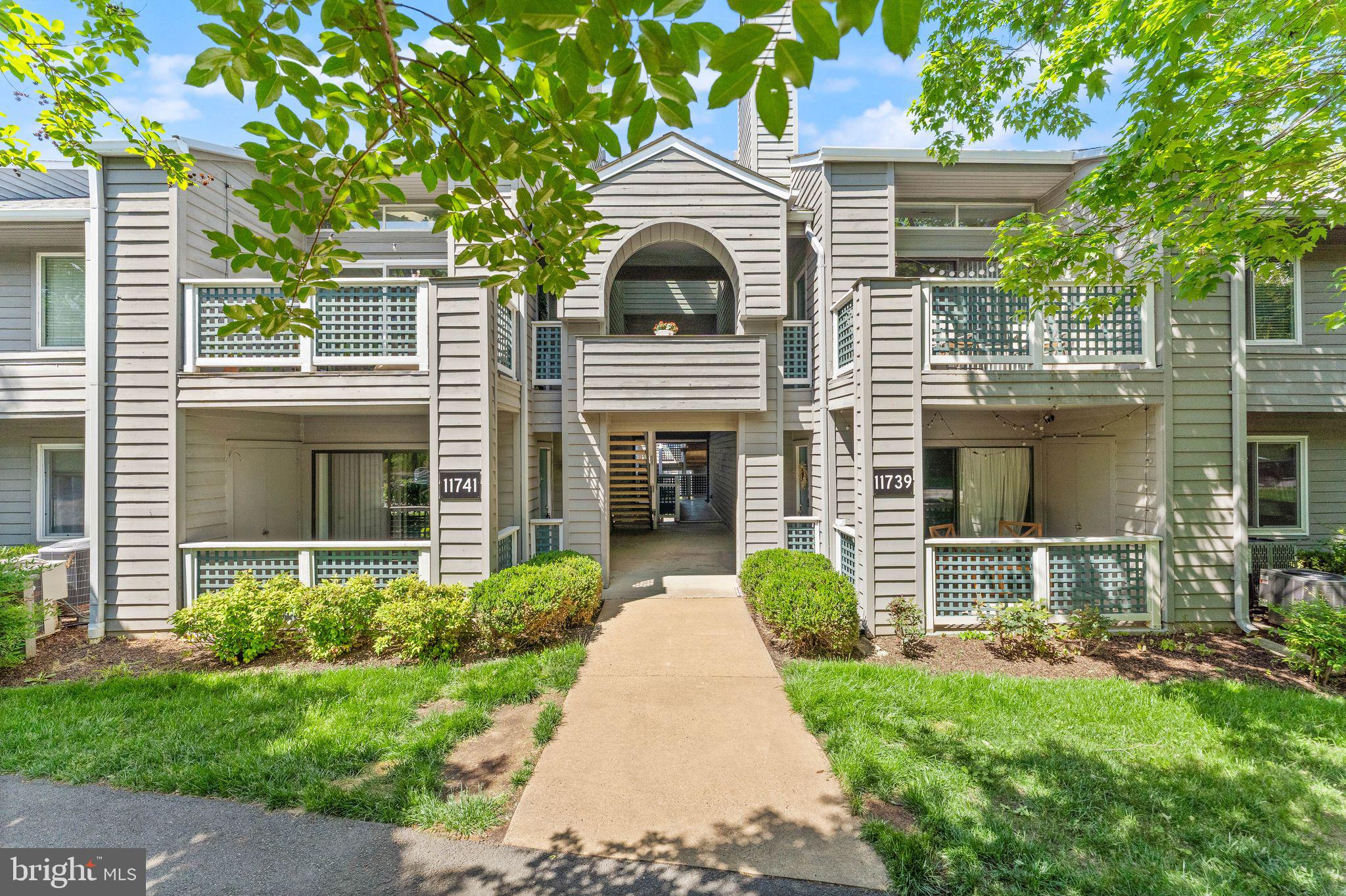 11741 Summerchase Circle, Unit A Reston, VA 20194 - Photo 2 of 32 a front view of a house with garden