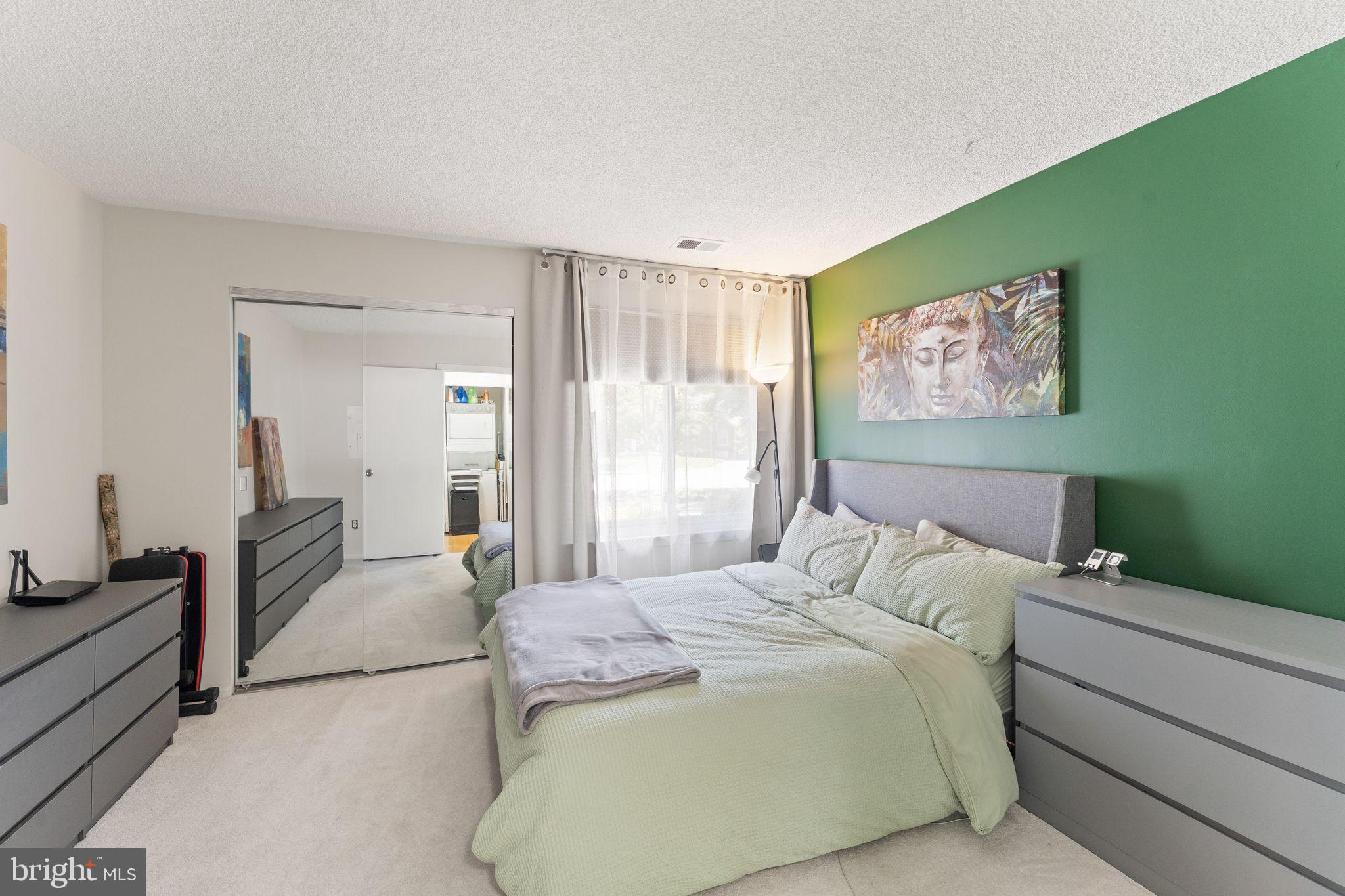 11741 Summerchase Circle, Unit A Reston, VA 20194 - Photo 21 of 32 a bedroom with a bed and a painting on the wall