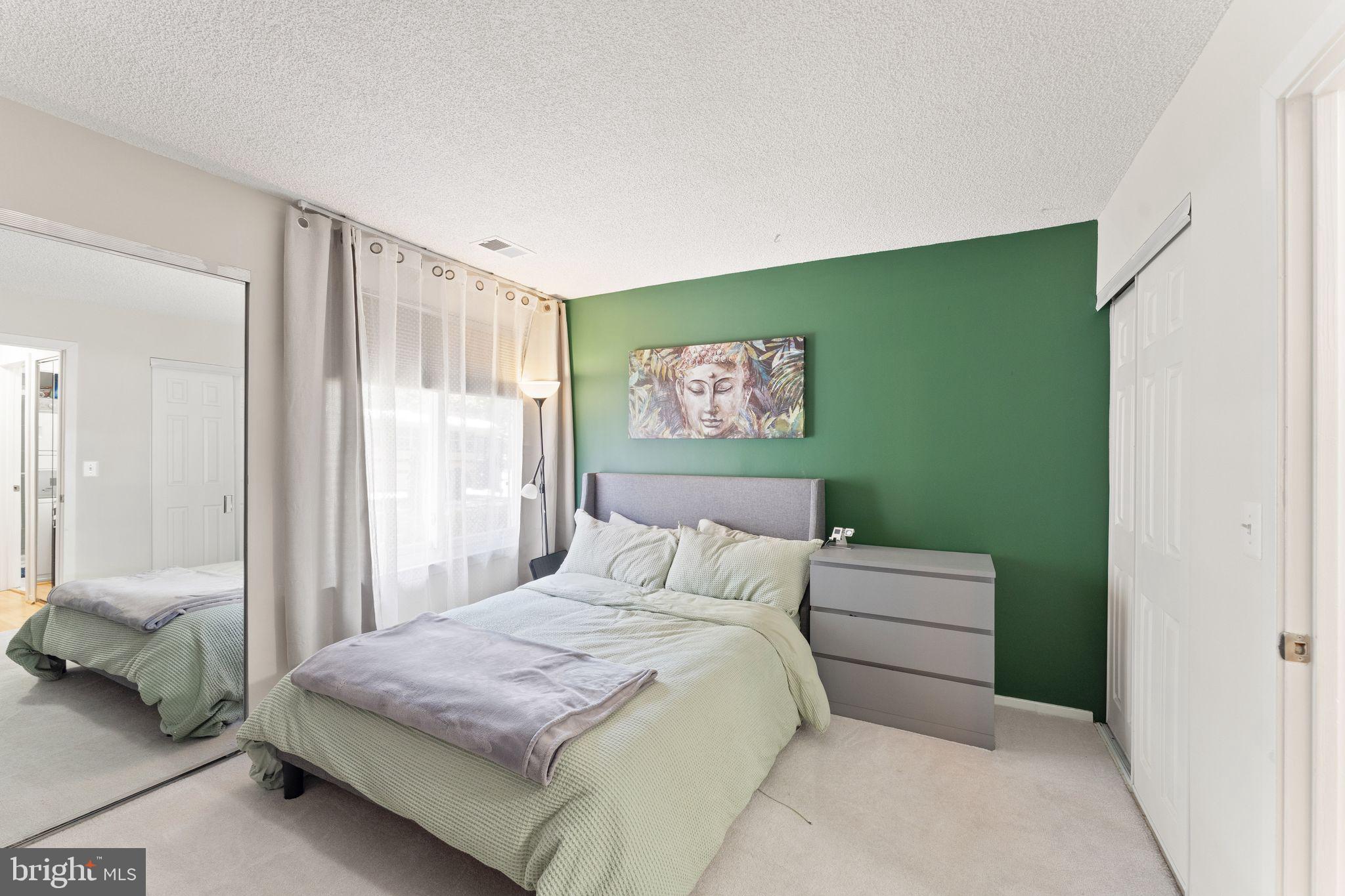 11741 Summerchase Circle, Unit A Reston, VA 20194 - Photo 22 of 32 a bedroom with a bed and a large mirror