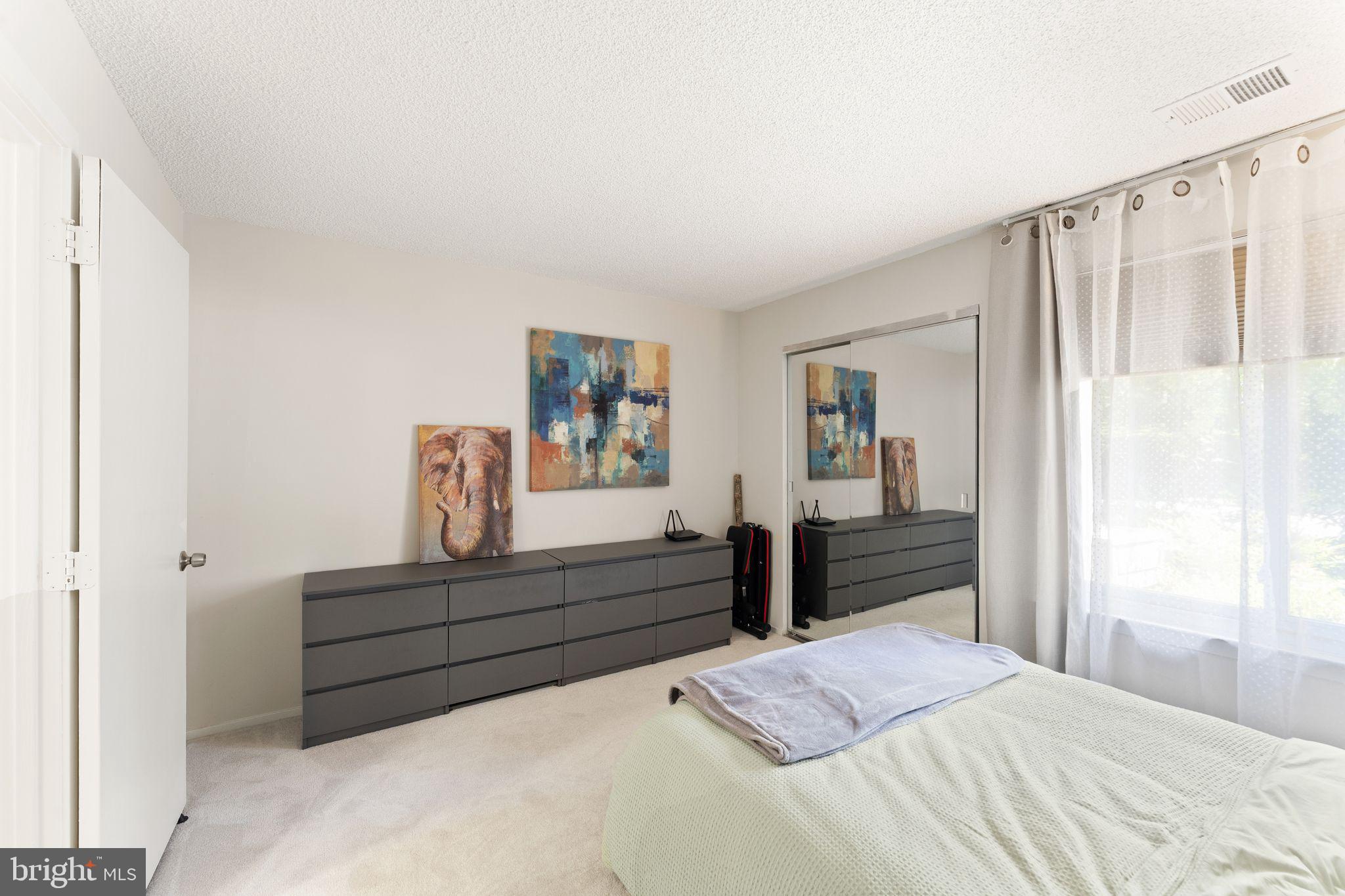 11741 Summerchase Circle, Unit A Reston, VA 20194 - Photo 23 of 32 a bedroom with a bed and window