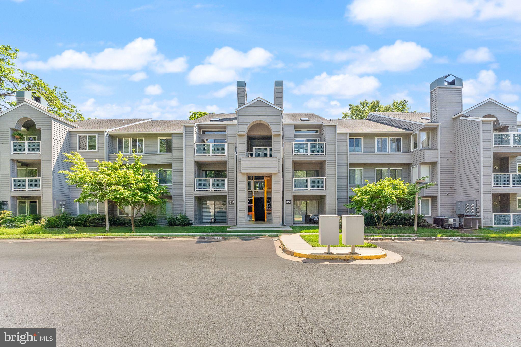 11741 Summerchase Circle, Unit A Reston, VA 20194 - Photo 30 of 32 a front view of building with yard and green space