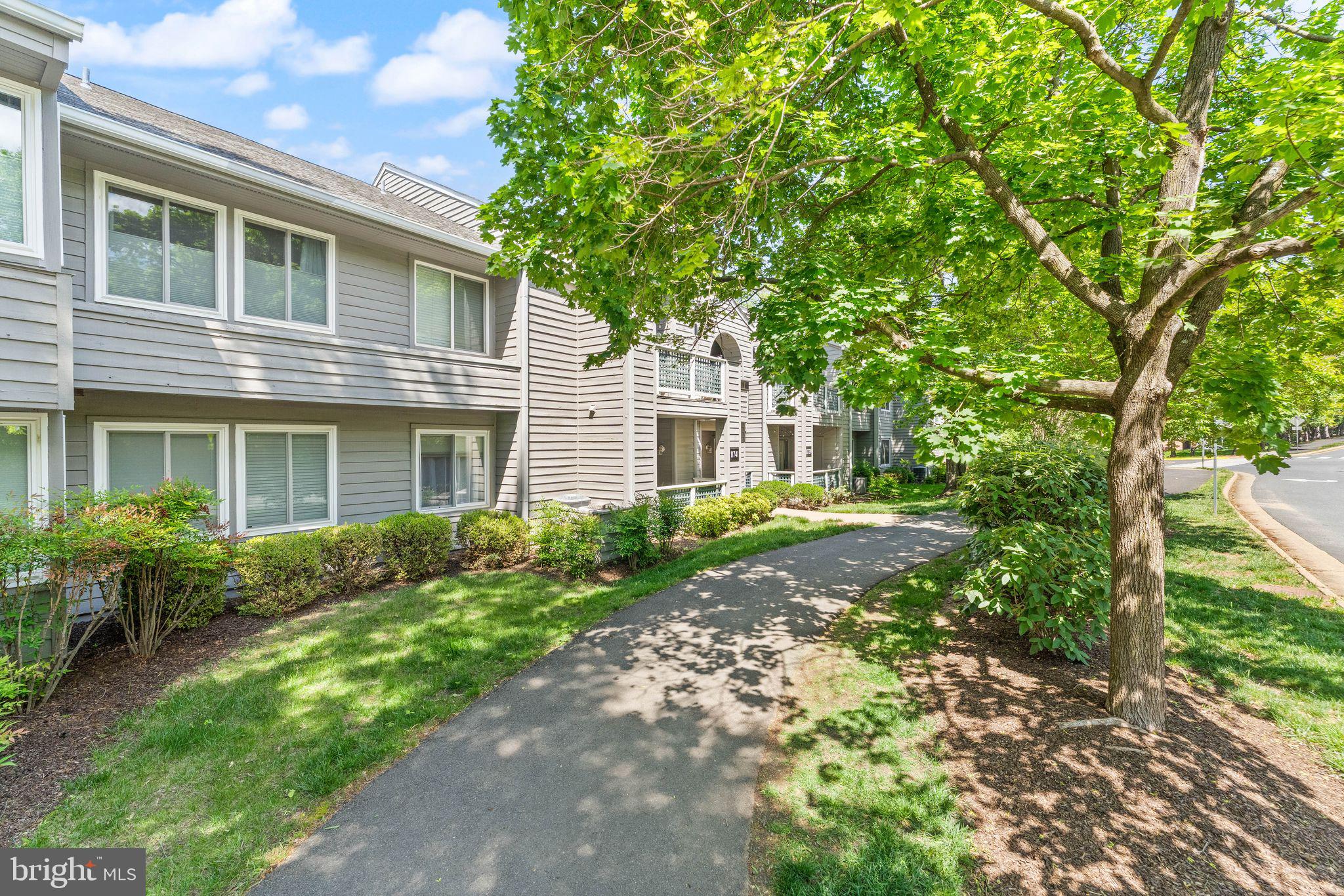 11741 Summerchase Circle, Unit A Reston, VA 20194 - Photo 3 of 32 a front view of a house with garden
