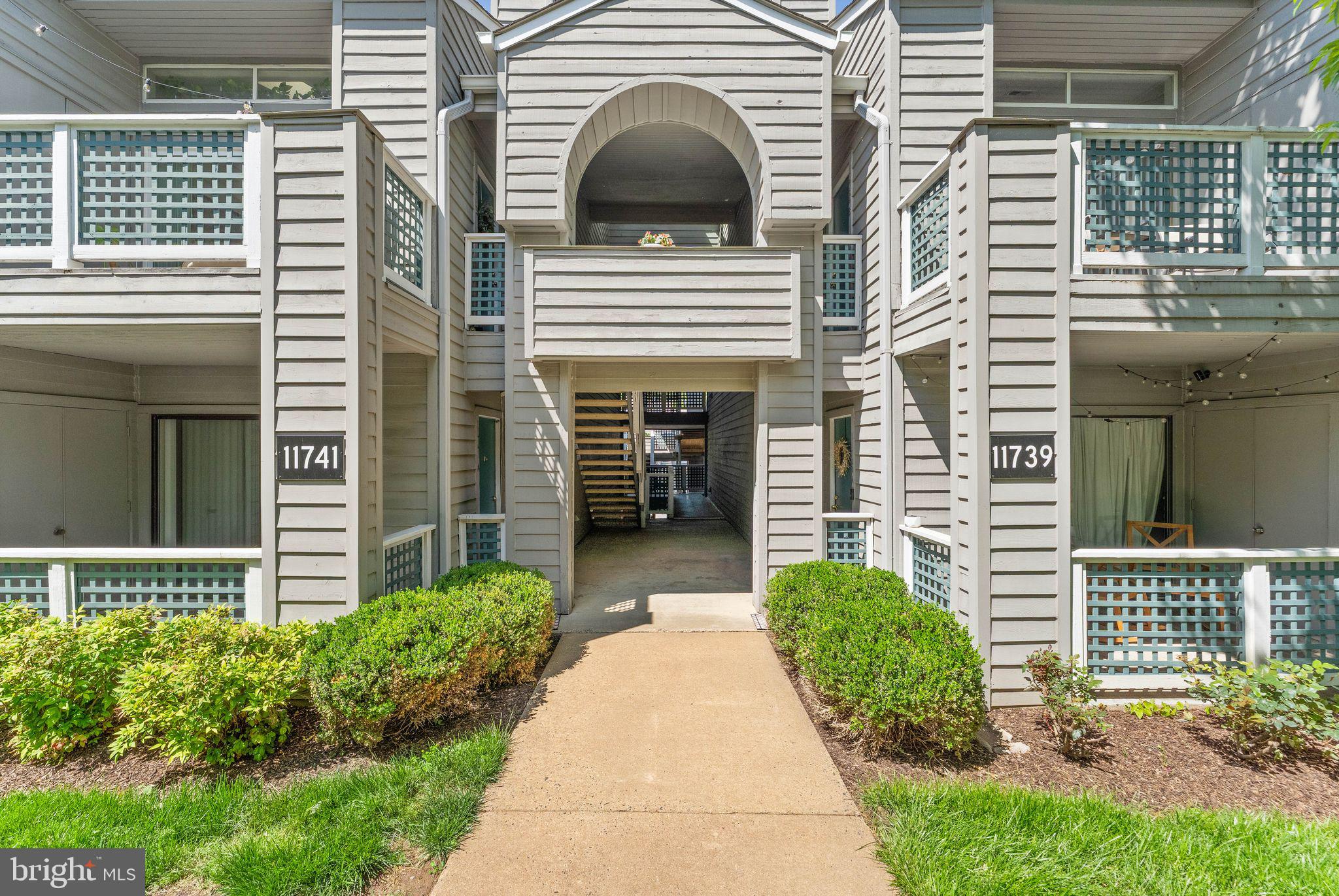 11741 Summerchase Circle, Unit A Reston, VA 20194 - Photo 4 of 32 a view of a house with more windows and a small yard
