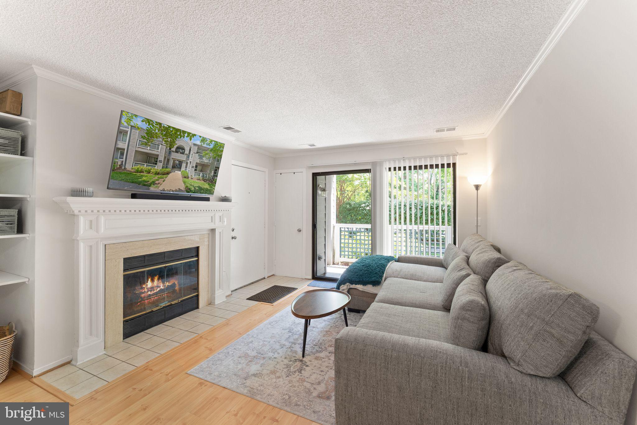 11741 Summerchase Circle, Unit A Reston, VA 20194 - Photo 10 of 32 a living room with furniture and a fireplace
