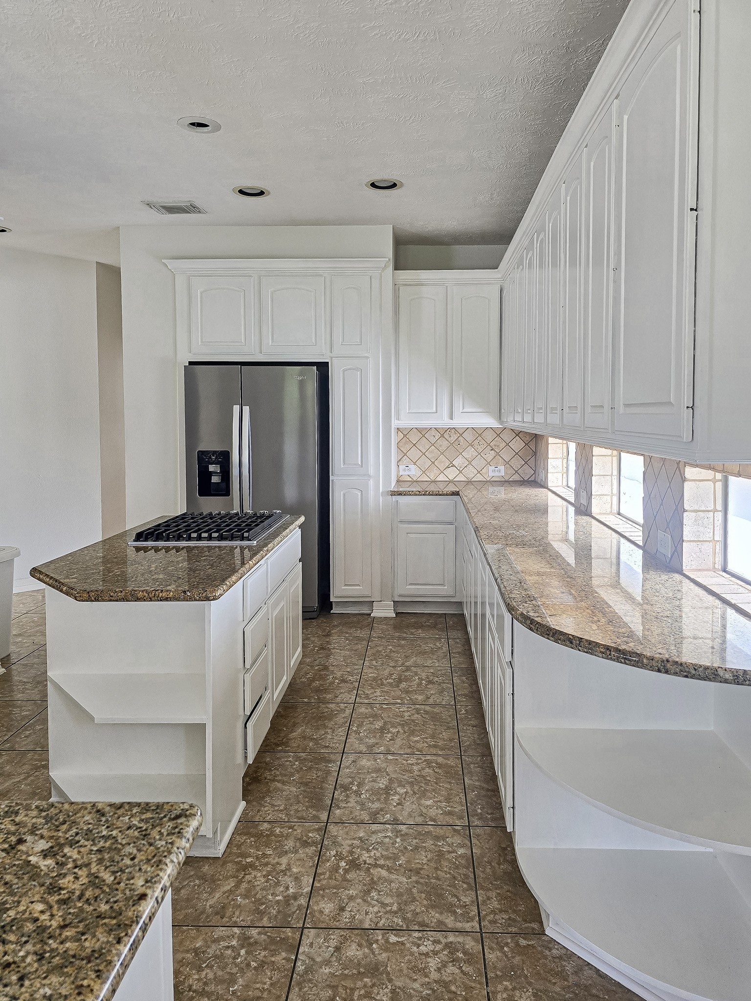 6506 Monte Bello Ridge Lane Houston, TX 77041 - Photo 5 of 39 This kitchen features elegant white cabinetry paired with luxurious granite countertops, creating a bright and inviting culinary space.