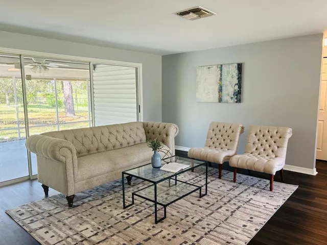 a living room with furniture rug and window