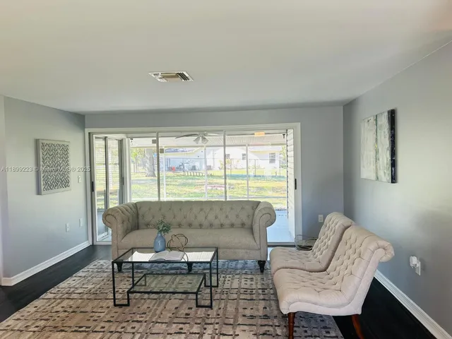 a living room with couch and wooden floor