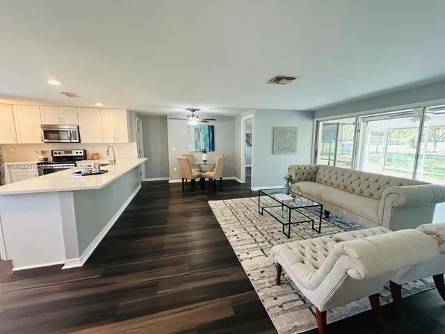 a large bedroom with a bed and wooden floor