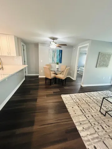 a spacious bedroom with a bed and wooden floor