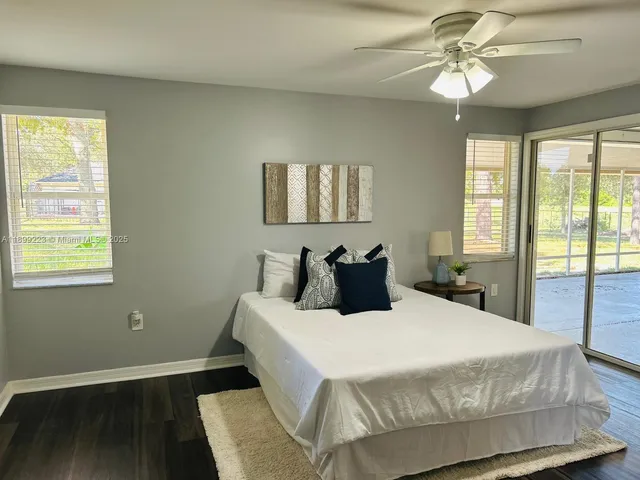 a view of wooden floor and windows in a room