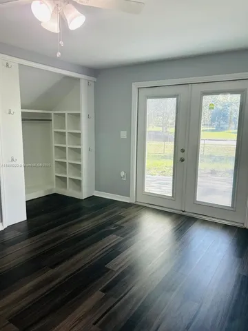 walk in closet with wooden floor washer and dryer