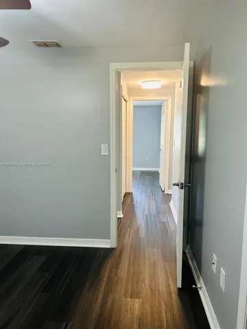 a bathroom with a double vanity sink toilet mirror and bathtub