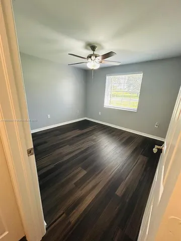 a view of a yard with plants and trees