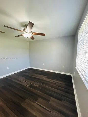 a view of a field with a tree in the background