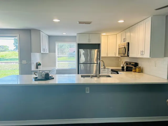 a living room with furniture and a dining table