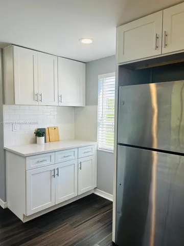 a kitchen with kitchen island a sink appliances and cabinets