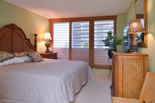 a bedroom with bed and a chandelier