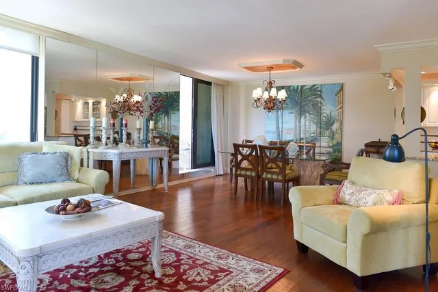 a living room with fireplace furniture and a large window