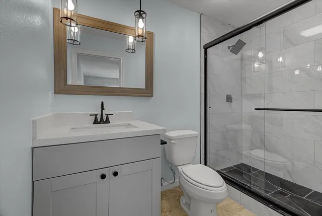 a bathroom with a toilet sink and shower