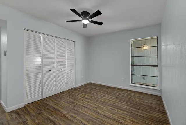 wooden floor in an empty room with a window