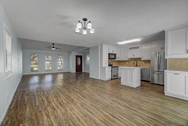 a view of kitchen with cabinets and wooden floor