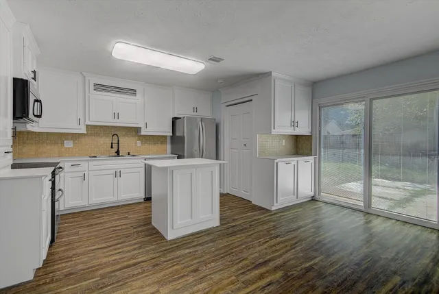 a kitchen with wooden cabinets and white appliances