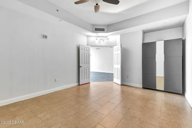a spacious bathroom with a granite countertop sink and a mirror
