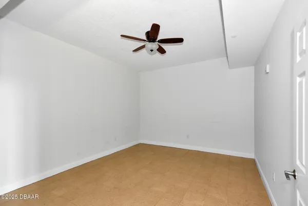 a view of room with window and wooden floor